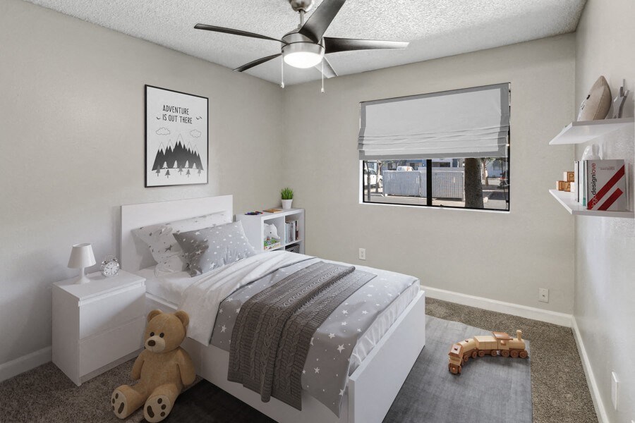 a bedroom with a ceiling fan and a window with a blind